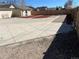Exterior showing concrete driveway leading to detached garage and mulched yard at 805 Park Ave, Fort Lupton, CO 80621