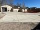 Exterior showing concrete driveway leading to open-backed garage with mulched yard at 805 Park Ave, Fort Lupton, CO 80621
