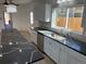 Well-lit kitchen with stainless steel appliances, tile backsplash, and stylish granite countertops at 805 Park Ave, Fort Lupton, CO 80621