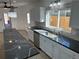 Well-lit kitchen with stainless steel appliances, tile backsplash, and stylish granite countertops at 805 Park Ave, Fort Lupton, CO 80621