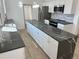 Bright kitchen featuring marble countertops, modern appliances, and white cabinets at 805 Park Ave, Fort Lupton, CO 80621