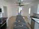 Open kitchen design featuring a large island, stainless appliances, and wood-look flooring at 805 Park Ave, Fort Lupton, CO 80621