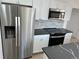 White cabinet kitchen with stainless steel appliances and dark marble countertops at 805 Park Ave, Fort Lupton, CO 80621