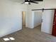 Bright living room features wood-look tile floors and a barn door at 805 Park Ave, Fort Lupton, CO 80621