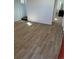 Bright living room features wood-look tile floors at 805 Park Ave, Fort Lupton, CO 80621