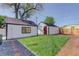A well kept backyard with an exterior of the home and a shed, with an area of grass at 141 S Knox Ct, Denver, CO 80219