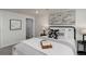 A bedroom with carpeted floors, a bed with a white comforter, and a black metal frame at 141 S Knox Ct, Denver, CO 80219