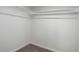 A simple walk-in closet space with carpeted floors, white walls and a shelf with a clothes rod at 141 S Knox Ct, Denver, CO 80219
