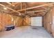 Unfinished garage with a white garage door and exposed framing at 141 S Knox Ct, Denver, CO 80219