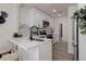 Modern kitchen with white cabinets, quartz countertops, and stainless steel appliances at 141 S Knox Ct, Denver, CO 80219