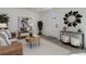 Cozy living room featuring a comfortable chair, rustic coffee table, and decorative mirror at 141 S Knox Ct, Denver, CO 80219