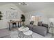Modern living room with vaulted ceilings, stylish lighting and a comfortable gray couch by a bright window at 141 S Knox Ct, Denver, CO 80219
