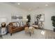 Cozy living room with a brown leather couch, decorative pillows, and stylish decor at 141 S Knox Ct, Denver, CO 80219