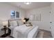 Cozy bedroom featuring a plush bed, soft lighting, modern decor and a large window at 141 S Knox Ct, Denver, CO 80219