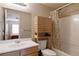 Bathroom with wood vanity, a large mirror, and a shower over tub at 2140 Santa Fe Dr, Longmont, CO 80504