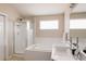 Bright bathroom featuring a tub, shower, and modern sink, all within a clean design at 2140 Santa Fe Dr, Longmont, CO 80504