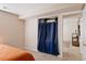Bedroom features neutral walls and flooring with a closet with blue curtains at 2140 Santa Fe Dr, Longmont, CO 80504