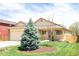 Charming home with manicured lawn, mature trees, a covered porch, and an attached garage at 2140 Santa Fe Dr, Longmont, CO 80504