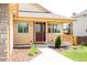 Charming front porch with decorative railings and an open door, inviting you to come inside at 2140 Santa Fe Dr, Longmont, CO 80504