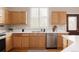 Kitchen featuring wood cabinets, stainless steel appliances, and a bright window over the sink at 2140 Santa Fe Dr, Longmont, CO 80504