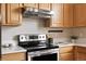 Range and vent hood, perfect for preparing meals in this well-equipped kitchen at 2140 Santa Fe Dr, Longmont, CO 80504