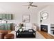 Cozy living room with fireplace and modern accents with green cabinets and light floors at 2140 Santa Fe Dr, Longmont, CO 80504