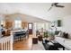 Open concept living area featuring a kitchen island, dining space, and comfortable seating at 2140 Santa Fe Dr, Longmont, CO 80504