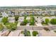 A residential neighborhood featuring single-Gathering homes with manicured lawns, tree-lined streets, and community amenities in the distance at 9272 Melborne Ct, Parker, CO 80134