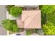 Aerial shot of a home with a symmetrical roof design, surrounded by lush greenery and neighboring houses at 9272 Melborne Ct, Parker, CO 80134