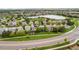 Wide aerial shot featuring residential homes surrounding a lake with greenbelts at 9272 Melborne Ct, Parker, CO 80134