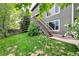 Green backyard with stairs leading to the upper level at 9272 Melborne Ct, Parker, CO 80134