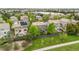 Aerial of backyard featuring mature trees, a fenced perimeter, and a lake in the distance at 9272 Melborne Ct, Parker, CO 80134