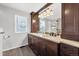 The neutral bathroom includes a double sink vanity, mirror and tile floors at 9272 Melborne Ct, Parker, CO 80134