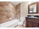 The bathroom features tile flooring and a tub/shower combo with a vanity and toilet at 9272 Melborne Ct, Parker, CO 80134