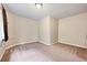 The carpeted room with neutral colored walls and base trim has ample space at 9272 Melborne Ct, Parker, CO 80134
