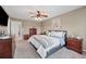 Relax in the main bedroom offering carpet, ceiling fan and an upholstered bed at 9272 Melborne Ct, Parker, CO 80134