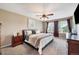 Relax in the main bedroom offering carpet, ceiling fan and an upholstered bed at 9272 Melborne Ct, Parker, CO 80134