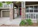 Inviting front porch with stone pillars and a red front door welcomes you home at 9272 Melborne Ct, Parker, CO 80134