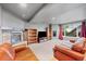 The finished basement features a gas fireplace, carpet, bookshelves, and a large window at 9272 Melborne Ct, Parker, CO 80134