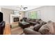 Cozy living room with a fireplace, plush sofas, and abundant natural light at 9272 Melborne Ct, Parker, CO 80134