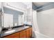 A full bathroom boasts a double sink with granite countertops and a shower-tub combination at 3952 S Carson St # 103, Aurora, CO 80014