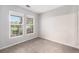 A bright, carpeted bedroom with large windows that let in natural light, offering relaxing space at 3952 S Carson St # 103, Aurora, CO 80014