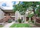 Charming two-story condo featuring stone accents, landscaped yard, wooden stairways, and ample natural light at 3952 S Carson St # 103, Aurora, CO 80014