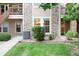 Close-up of a condo's exterior showing stone accents, manicured landscaping, and well-maintained walkways at 3952 S Carson St # 103, Aurora, CO 80014