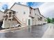 The exterior of the property features beige siding, a green door, garages, and multiple mailboxes at 3952 S Carson St # 103, Aurora, CO 80014
