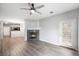 Stylish living room with a fireplace, ceiling fan, a door to the patio, and modern vinyl plank flooring at 3952 S Carson St # 103, Aurora, CO 80014