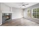 Spacious living room featuring a cozy fireplace, a patio door, and large windows offering ample natural light at 3952 S Carson St # 103, Aurora, CO 80014