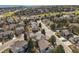 An aerial view of a peaceful neighborhood showcasing lush green spaces and well-maintained homes at 598 Stonemont Dr, Castle Pines, CO 80108