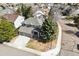A gray home with stone accents sits on a landscaped corner lot at 598 Stonemont Dr, Castle Pines, CO 80108