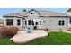 A beautiful backyard showcases a blue patio set and lush green lawn, perfect for relaxing outdoors at 598 Stonemont Dr, Castle Pines, CO 80108